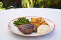 Roasted beef steak from tenderloin, potatoes, beans and tartar sauce. Royalty Free Stock Photo