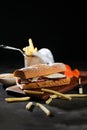 Roasted Beef Sub Sandwich with french fries bucket served on wooden board isolated on dark background side view of breakfast food Royalty Free Stock Photo