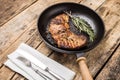 Roasted beefsteak with bunch of rosemary on grill pan