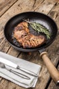 Roasted beefsteak with bunch of rosemary on grill pan