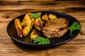Roasted beefsteak with the fried potato and parsley Royalty Free Stock Photo
