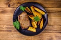 Roasted beefsteak with the fried potato and parsley. Top view