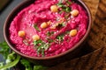 Roasted Beet Hummus with toast in a ceramic bowl