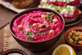 Roasted Beet Hummus with toast in a ceramic bowl