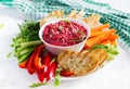 Roasted beet hummus with toast and vegetables. Beetroot hummus. Royalty Free Stock Photo
