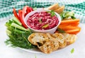 Roasted beet hummus with toast and vegetables. Beetroot hummus. Royalty Free Stock Photo