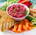 Roasted beet hummus with toast and vegetables. Beetroot hummus. Royalty Free Stock Photo
