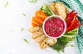Roasted beet hummus with toast and vegetables. Beetroot hummus. Royalty Free Stock Photo