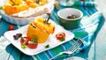Roasted bell pepper stuffed with quinoa, mushrooms and cheddar cheese with addition aromatic tomatoes Royalty Free Stock Photo