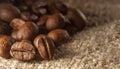Roasted Black coffee beans on Burlap Sack background. Aroma ingredients. close up. coffee Royalty Free Stock Photo