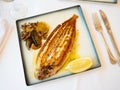Roasted black sole fish with stewed vegetables and lemon Royalty Free Stock Photo