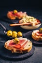 Roasted bread with garlic butter spread and serano ham and olive Royalty Free Stock Photo