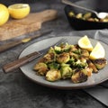 Roasted brussels sprouts portion. Healthy, homemade vegan food or loose weight. Dark background, square image
