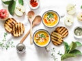 Roasted butternut squash and apples paleo diet vegetarian soup on light background, top view. Royalty Free Stock Photo