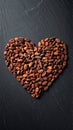 Roasted Cacao Beans Arranged in Heart Shape on Dark Slate Background Royalty Free Stock Photo