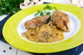 Roasted carp steaks with mushroom sauce on a plate on a white wooden background. Royalty Free Stock Photo