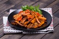 Roasted carrots in black plate, close up