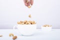 Roasted cashew nut in bowl  on white background Royalty Free Stock Photo