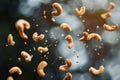 Roasted cashew nuts falling and rotating on dark background Royalty Free Stock Photo