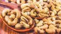 Roasted cashew nuts on a wooden spoon.Roasted salted cashew nuts on white background Royalty Free Stock Photo