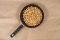 Roasted cashews in frying pan on paper Royalty Free Stock Photo