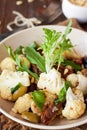 Roasted cauliflower salad with olives, tomatoes, nuts and basil Royalty Free Stock Photo