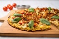 roasted cauliflower pizza on a wooden board