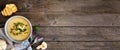 Roasted cauliflower and potato and soup. Top view table scene, banner with corner border over a rustic wood background Royalty Free Stock Photo