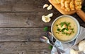 Roasted cauliflower and potato and soup. Top view table scene, side border over a rustic wood background Royalty Free Stock Photo