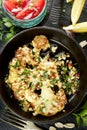 Roasted cauliflower steak with the addition dip with peanuts, chili and fresh parsley on iron frying pan