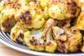 Roasted cauliflower in white plate on wooden background
