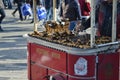 Roasted chestnut vendor, traditional mobile tray with chestnut in a main street in Istanbul