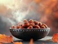 Roasted Chestnuts in a Bowl with Steam and Fall Leaves Royalty Free Stock Photo
