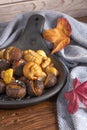Roasted chestnuts in cast iron pan on an old board Royalty Free Stock Photo