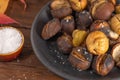 Roasted chestnuts in cast iron pan on an old board Royalty Free Stock Photo