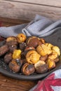 Roasted chestnuts in cast iron pan on an old board Royalty Free Stock Photo