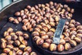 Roasted chestnuts in a frying pan somewhere in the street market Royalty Free Stock Photo