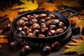 Roasted chestnuts in a pan on a wooden background