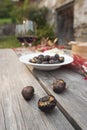 Roasted chestnuts and red wine on table Royalty Free Stock Photo