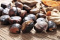 Roasted chestnuts on a rustic wooden table Royalty Free Stock Photo