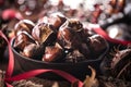 Roasted chestnuts served in a special perforated chestnut pan on an old wooden table. Royalty Free Stock Photo