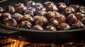 Roasted chestnuts with sugar and spice salt presented in a grill pan. Typical autumn dish. Taste chestnuts roasted