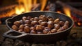 Roasted chestnuts with sugar and spice salt presented in a grill pan. Typical autumn dish. Taste chestnuts roasted