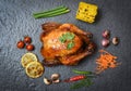 Roasted chicken / baked whole chicken grilled with on herbs and spices and dark background on top view Royalty Free Stock Photo