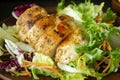 Roasted chicken breast with mix salad of chicory, cabbage and lettuce on a plate close up. Royalty Free Stock Photo