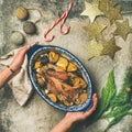 Roasted chicken for Christmas eve celebration table in woman`s hands Royalty Free Stock Photo