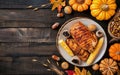 Roasted Chicken With Corn and Pumpkins on a Dark Wooden Table Royalty Free Stock Photo