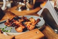 Roasted Chicken or fried quail with berries and apple sauce and micro greens on plate over black background. Hot Meat Royalty Free Stock Photo