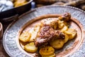 Roasted chicken leg with potatoes with caraway and garlic Royalty Free Stock Photo