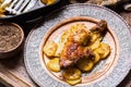 Roasted chicken leg with potatoes with caraway and garlic Royalty Free Stock Photo